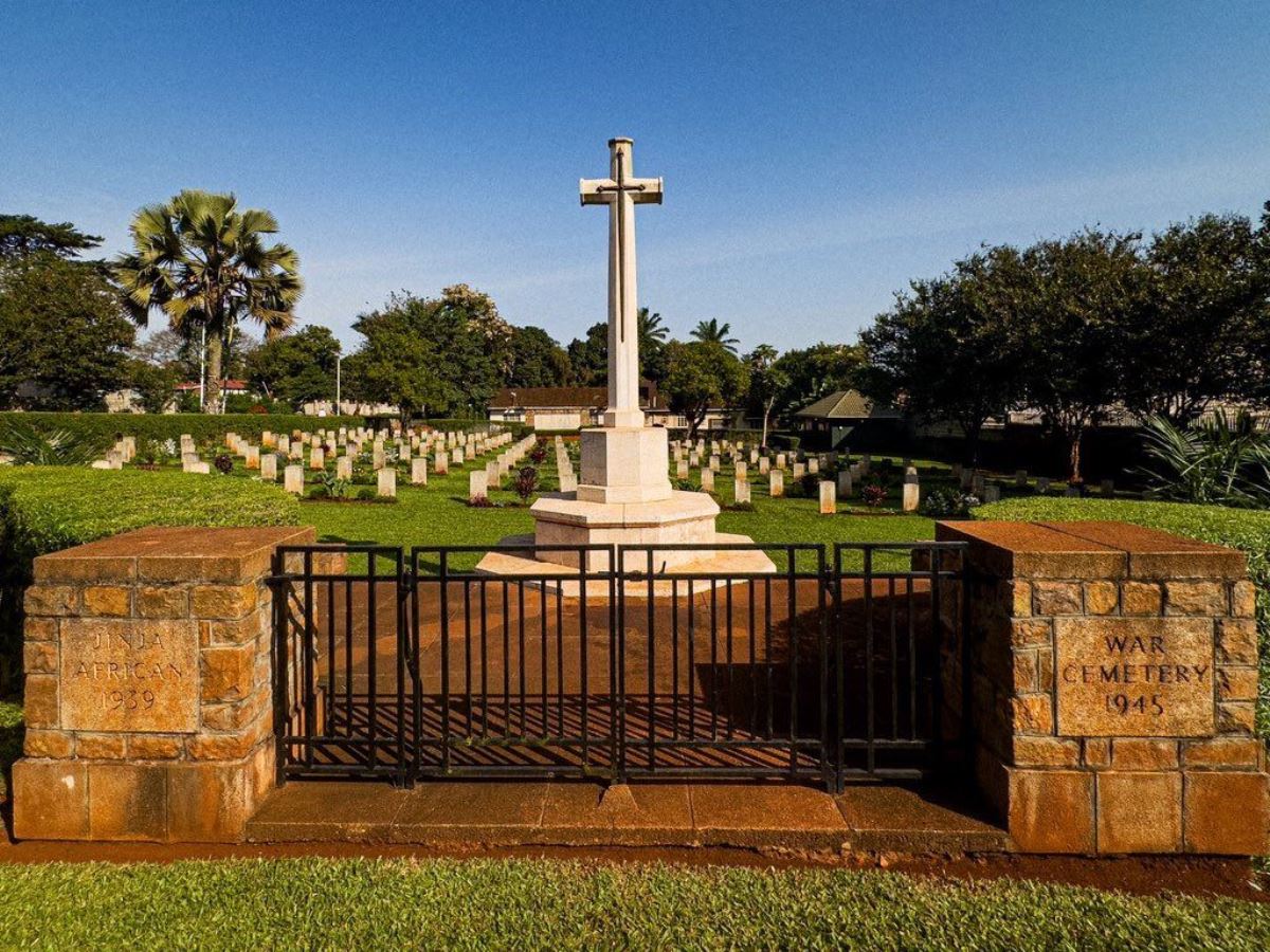 Photograph of Jinja War Cemetery, a peaceful and well-kept graveyard where rows of white headstones mark the final resting places of both European and African soldiers who died during World War I and World War II in Jinja, Eastern Uganda