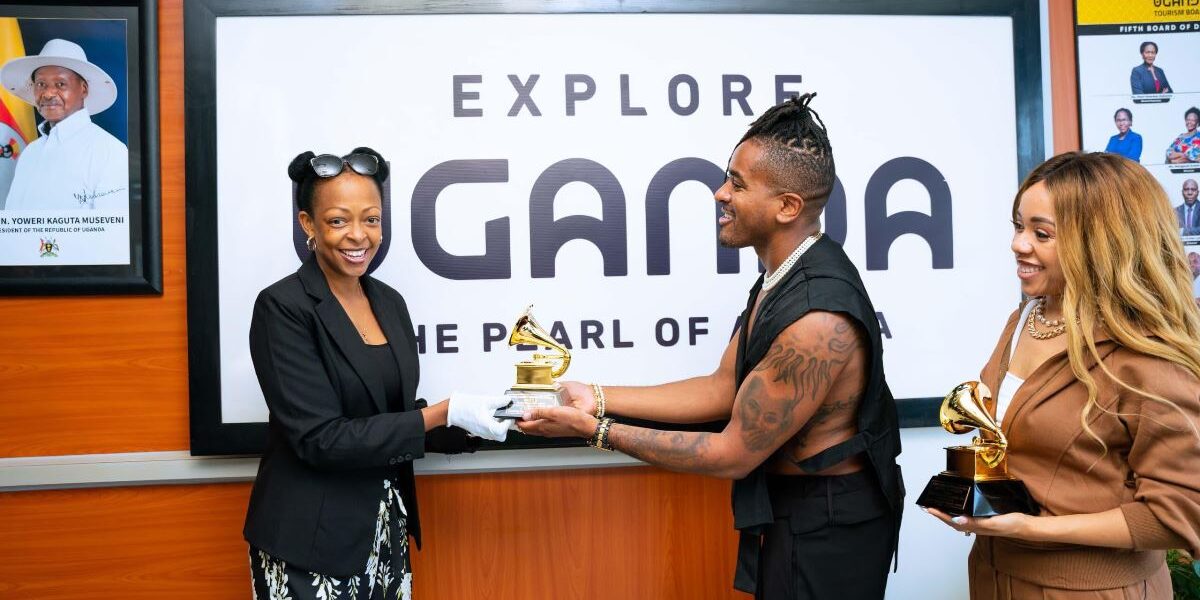 Photograph of Uganda Tourism Board's CEO Ms. Juliana Kagwa holding a Grammy with American Grammy-winning artist Matt B