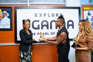Photograph of Uganda Tourism Board's CEO Ms. Juliana Kagwa holding a Grammy with American Grammy-winning artist Matt B