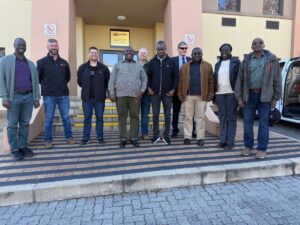 Photograph of Hon.Bahinduka Mugarra Martin and team taken during a bench marking trip to South Africa on best lion conservation strategies