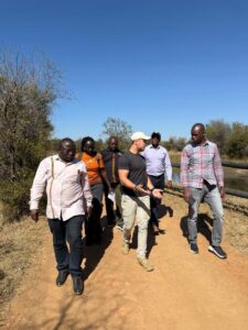 Photograph of Hon.Bahinduka Mugarra Martin and team taken during a bench marking trip to South Africa on best lion conservation strategies