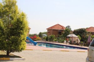 Photograph showing the property exterior and swimming pool at Kashari Farm Resort in Mbarara, Uganda