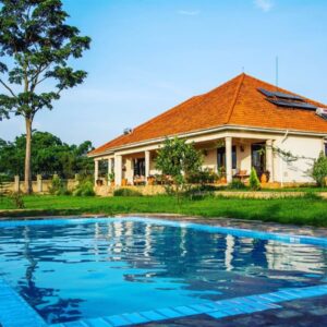 Photograph showing property exterior and swimming pool at Martha's Farmhouse in Mukono, Uganda
