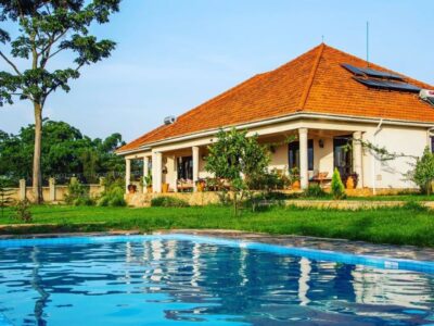 Photograph showing property exterior and swimming pool at Martha's Farmhouse in Mukono, Uganda