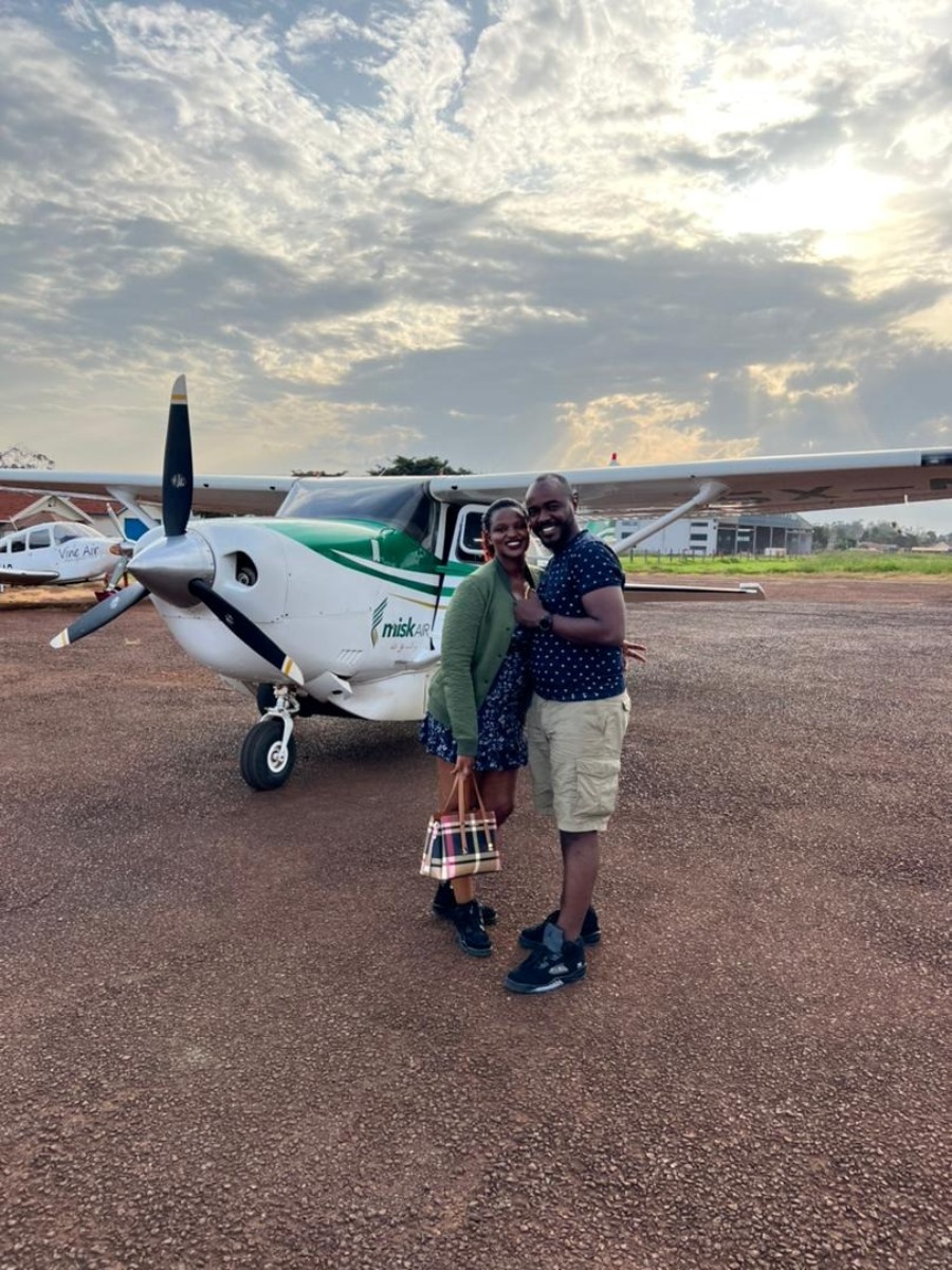 Photograph of tourists infront of the small plane taken during a Jinja Scenic Flight tour