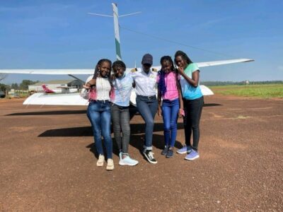 Photograph of tourists infront of the small plane taken during a Jinja Scenic Flight tour