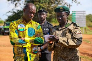 Photograph taken during Hon. Bahinduka Mugarra Martin's inspection of the installation works of an electric fence at Lokumoit Ranger Post in Kidepo Valley National Park
