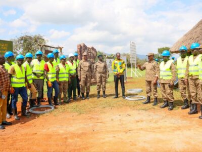 Photograph taken during Hon. Bahinduka Mugarra Martin's inspection of the installation works of an electric fence at Lokumoit Ranger Post in Kidepo Valley National Park