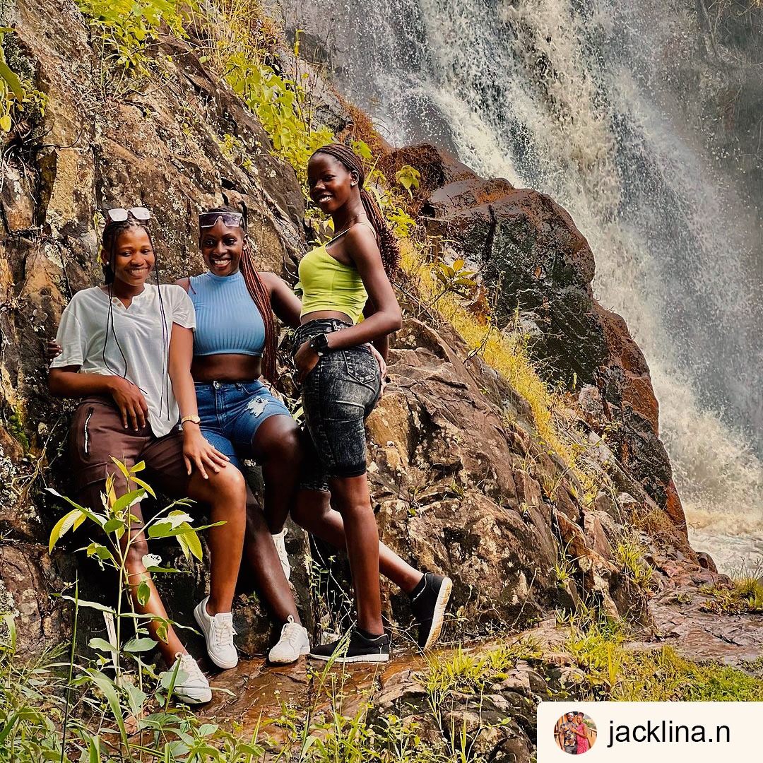 Young Uganda youth standing at thc rock with Ssezibwa Forest in the background. Photography by Ssezibwa Falls Resort Mukono Uganda