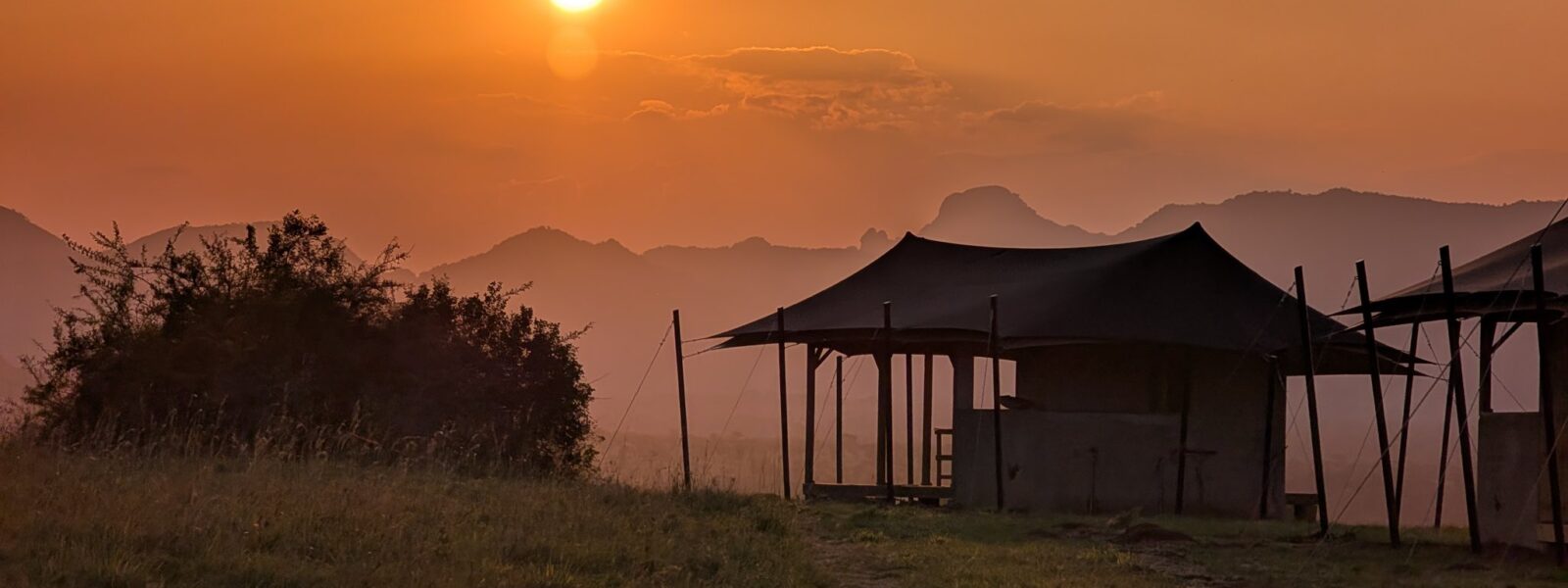 Sunrise at Namoni Lodge with tented accommodations overlooking the savanna in Kidepo Valley National Park, Uganda