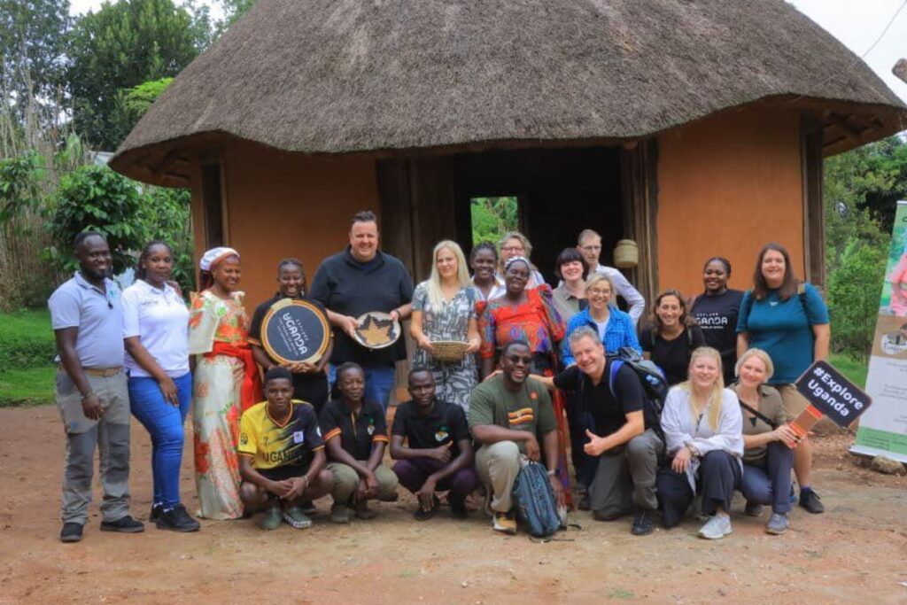 Group photograph of German travel agents taken during a cultural tour at the Ewaffe Cultural Village in Mukono, Uganda