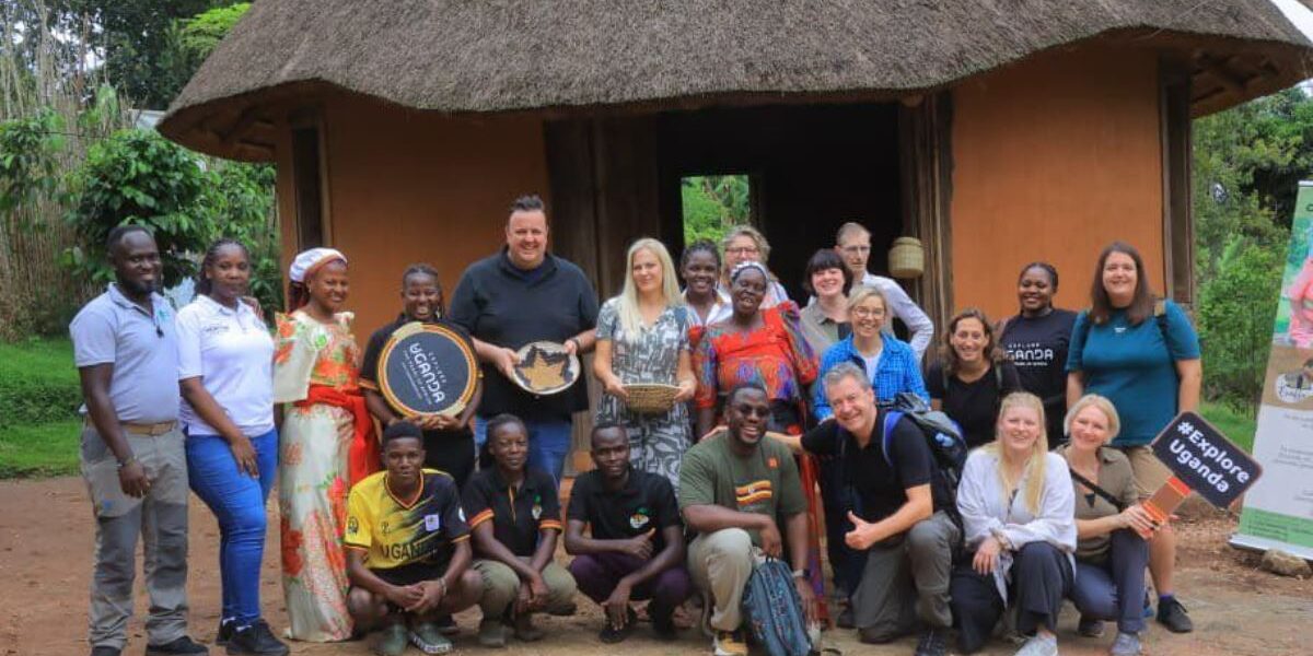 Group photograph of German travel agents taken during a cultural tour at the Ewaffe Cultural Village in Mukono, Uganda