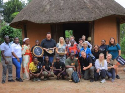 Group photograph of German travel agents taken during a cultural tour at the Ewaffe Cultural Village in Mukono, Uganda