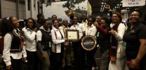 Photograph of the Ugandan team posing with the “Best in Show – Africa” award for its immersive and experiential showcase at the Travel & Adventure Show