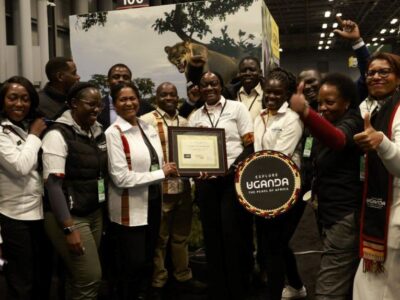 Photograph of the Ugandan team posing with the “Best in Show – Africa” award for its immersive and experiential showcase at the Travel & Adventure Show