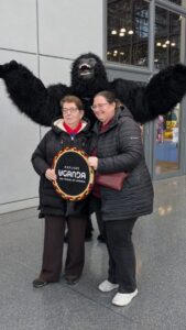 Enthusiastic visitors pose with Uganda's beloved gorilla mascot and the iconic Explore Uganda drum, showcasing the country's world-renowned wildlife heritage and warm hospitality at a global promotion event