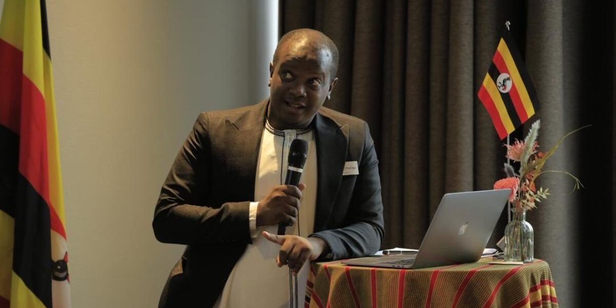 Uganda Tourism Board representative delivering a keynote address at the Uganda Tourism Symposium in Copenhagen, highlighting opportunities for sustainable tourism collaborations between Uganda and Nordic-Baltic nations