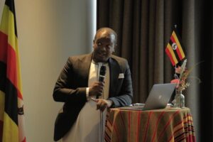Uganda Tourism Board representative delivering a keynote address at the Uganda Tourism Symposium in Copenhagen, highlighting opportunities for sustainable tourism collaborations between Uganda and Nordic-Baltic nations