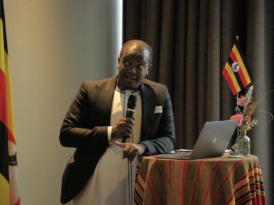 Uganda Tourism Board representative delivering a keynote address at the Uganda Tourism Symposium in Copenhagen, highlighting opportunities for sustainable tourism collaborations between Uganda and Nordic-Baltic nations