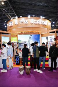 Visitors explore Uganda’s exhibition pavilion at the Tourism Plus Expo in Shanghai, engaging with cultural displays, crafts, and tourism information