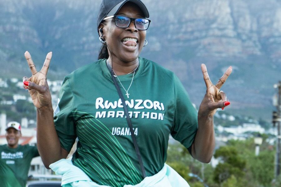 A happy participant promotes the Rwenzori Marathon, Uganda, against the stunning backdrop of Table Mountain