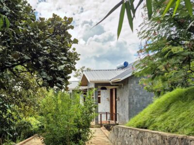 A family cottage at Mirima Kibale Lodge blends seamlessly into the lush landscape overlooking Lake Nyamirima Family cottage at Mirima Kibale Lodge surrounded by lush greenery near Kibale National Park