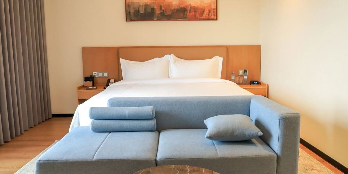 Stylish and comfortable guest room at the new Bamus Sarovar Portico Kampala. The hotel features contemporary design, premium bedding, and a relaxing seating area, perfect for both leisure travelers and business guests.