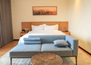 Stylish and comfortable guest room at the new Bamus Sarovar Portico Kampala. The hotel features contemporary design, premium bedding, and a relaxing seating area, perfect for both leisure travelers and business guests.