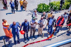 High Commission officials and partners cut the ribbon during the official launch of the Uganda-branded double-decker bus in Ottawa