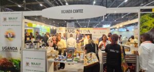 Visitors and coffee professionals at the vibrant Uganda Coffee pavilion at the World of Coffee Brussels event 2026