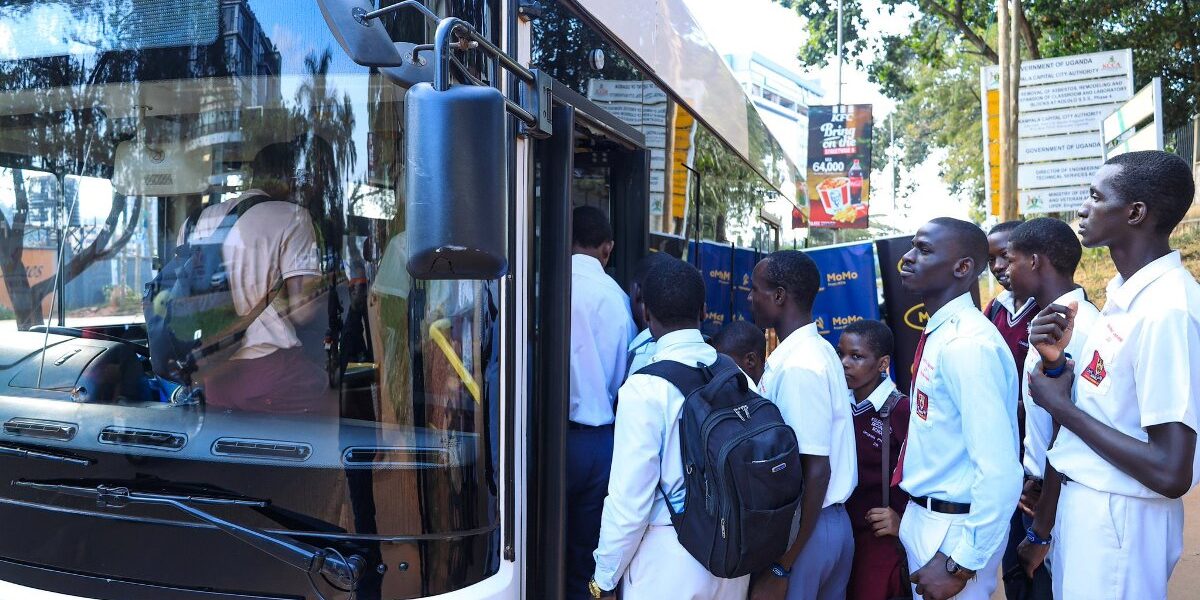 Students in smart uniforms queue to board the new E-Bus Xpress electric vehicle using their MTN MoMo-powered wristbands at the launch of the smart school transport solution in Kampala