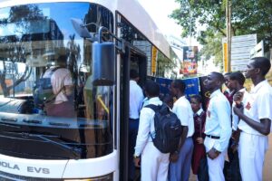 Students in smart uniforms queue to board the new E-Bus Xpress electric vehicle using their MTN MoMo-powered wristbands at the launch of the smart school transport solution in Kampala