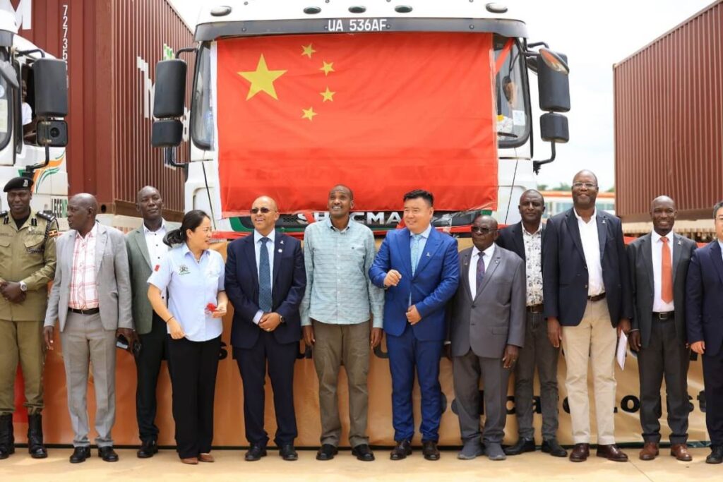 Ugandan officials, led by Agriculture Minister Frank Tumwebaze, pose with Chinese partners in front of the truck carrying the historic first shipment of Ugandan canned pineapples to China