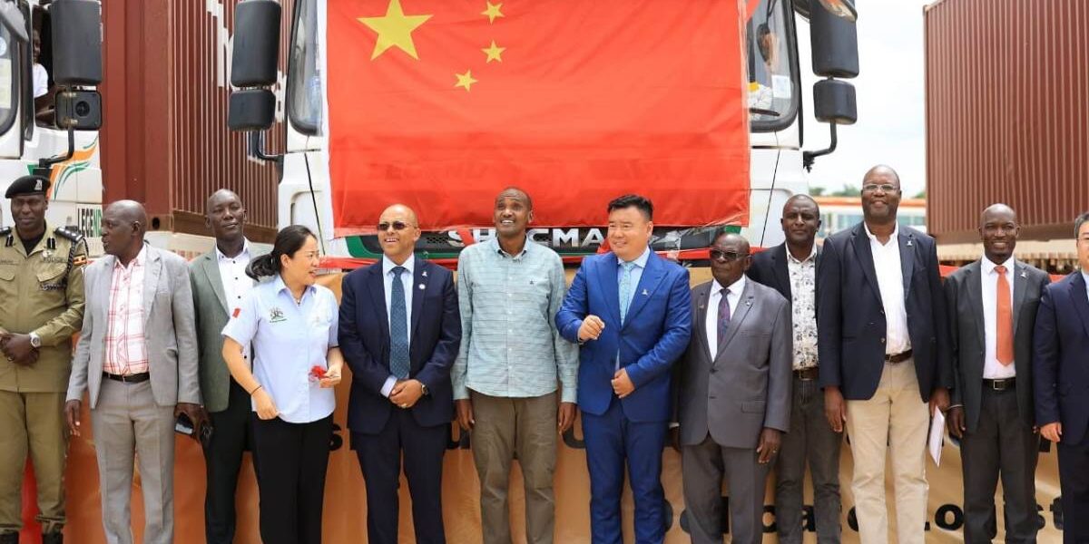 Ugandan officials, led by Agriculture Minister Frank Tumwebaze, pose with Chinese partners in front of the truck carrying the historic first shipment of Ugandan canned pineapples to China