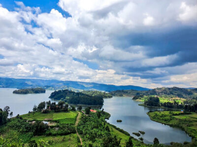 Breathtaking vistas of Lake Bunyonyi, Uganda, where emerald hills embrace crystal waters and islands dot the horizon under dramatic skies. A jewel of the Kigezi region, inviting exploration and serenity