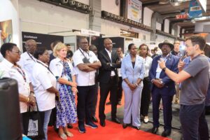 Ugandan delegation and international partners engage with industry experts at the Uganda Coffee booth during the World of Coffee Brussels 2026 exhibition