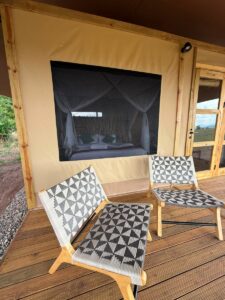 Luxurious tented accommodation at Namoni Lodge with private deck seating and elegant bedroom interiors, offering immersive yet comfortable safari stays from August 2026