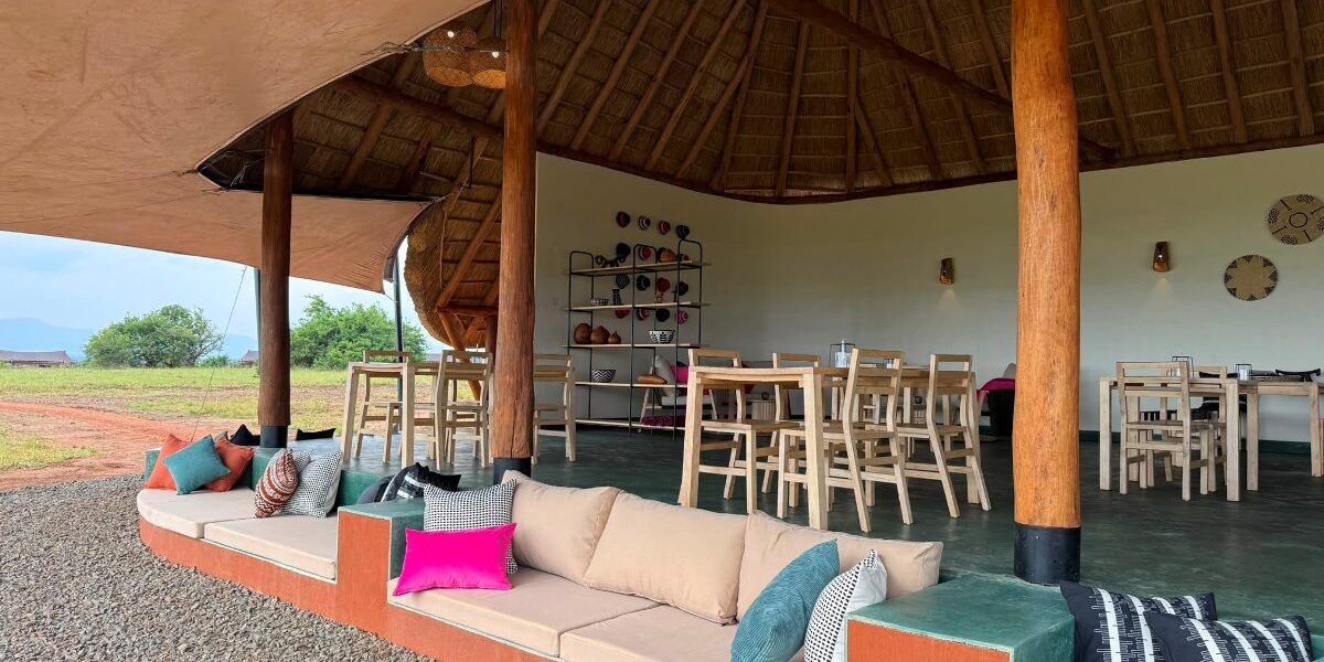 Stylish communal lounge at Namoni Lodge featuring comfortable outdoor seating and traditional thatched architecture, blending seamlessly with the Karamoja landscape