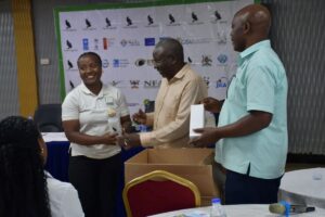 A representative at NatureUganda’s Annual General Meeting receives a recognition Award for outstanding contribution to conservation, celebrated by fellow members and partners