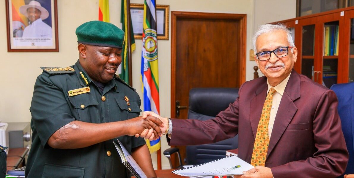 Uganda Wildlife Authority Executive Director Dr. James Musinguzi (left) and a Marasa Africa representative shake hands after formalising the 30-year renewal of concession agreements for Paraa, Mweya and Chobe Safari Lodges
