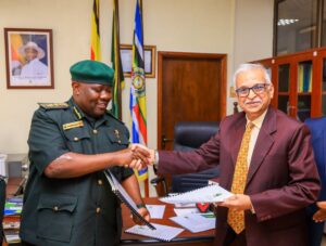 Uganda Wildlife Authority Executive Director Dr. James Musinguzi (left) and a Marasa Africa representative shake hands after formalising the 30-year renewal of concession agreements for Paraa, Mweya and Chobe Safari Lodges