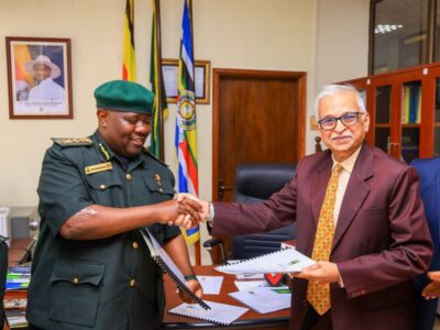 Uganda Wildlife Authority Executive Director Dr. James Musinguzi (left) and a Marasa Africa representative shake hands after formalising the 30-year renewal of concession agreements for Paraa, Mweya and Chobe Safari Lodges