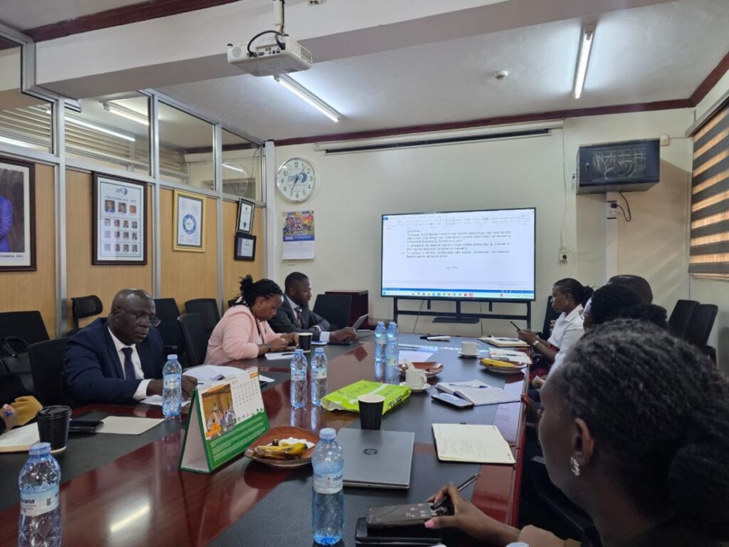 Stakeholders review documents and discuss strategies during a planning session for the Uganda-Kenya Coast Tourism & Innovation Summit, focused on unlocking regional tourism opportunities through technology, youth, and seamless mobility