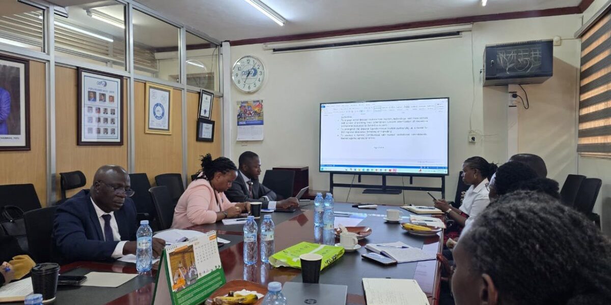 Stakeholders review documents and discuss strategies during a planning session for the Uganda-Kenya Coast Tourism & Innovation Summit, focused on unlocking regional tourism opportunities through technology, youth, and seamless mobility