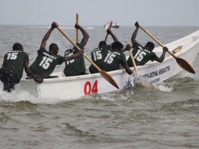 Competitors from the Buweekula team paddle vigorously in a traditional canoe during the Buganda Royal Regatta at Bunjako Beach, sending up sprays of water as they race across the lake Competitors from the Buweekula team paddle vigorously in a traditional canoe during the Buganda Royal Regatta at Bunjako Beach, sending up sprays of water as they race across the lake