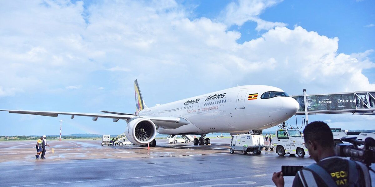 A Uganda Airlines aircraft stands on the tarmac at Entebbe International Airport, showcasing the national carrier’s distinctive “Pearl of Africa” livery
