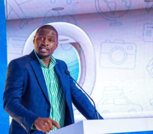 Next Travel Managing Director Jonathan Martin Kyeyo addresses guests at the official launch of the Travel by MoMo platform, which enables users to book domestic and international flights directly through the MTN MoMo app