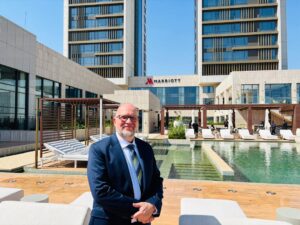 Luxury outdoor pool and twin towers of the newly opened Kampala Marriott Hotel in Nsambya under clear blue skies