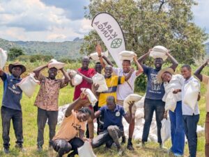 Participants and volunteers of the Karamoja Hunger Run 2026 celebrate the successful distribution of food aid, standing united under the Kara-Tunga banner in support of a hunger-free Karamoja