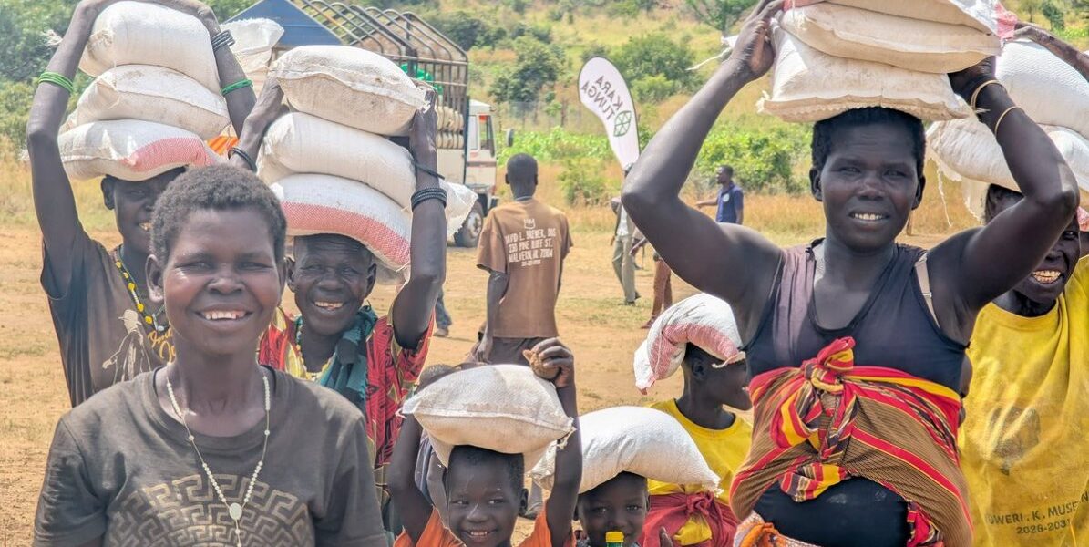 Community members in Karamoja carry vital food relief supplies following the 2026 Karamoja Hunger Run, turning solidarity into tangible support for families facing drought-related shortages